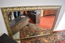 A modern wall mirror having relief ivy decoration approx. 101 x 132cm