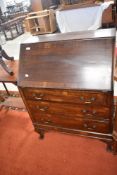 A 20th century mahogany bureau, of typical arrangement on short cabriole type legs 104cm x 75cm x