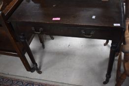 A late 19th/early 20th century mahogany sofa table, with rounded end leaves, two frieze drawers