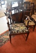 An early 20th century mahogany carver chair having scroll arms