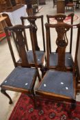 A set of four early 20th Century stained frame dining chairs having drop in seats