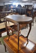 An Edwardian mahogany occasional table, with shaped top and cabriole type legs 73cm sold along