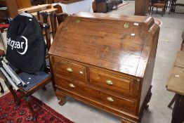 An Oriental teak bureau , the flap having campaign style handles, width approx. 100cm