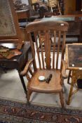 A 19th century stained frame carver chair in the Windsor style having vase and slat back with turned