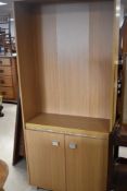 A beech laminate bookshelf with double cupboard under, dimensions approx. H180 W79 D30cm