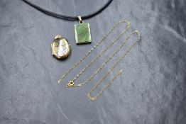 A 9ct gold locket pendant, having decorative floral and scroll engraving, marked 375, along with a