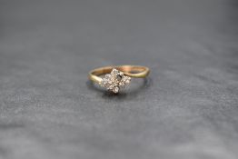 A 9ct gold diamond set cluster ring, the central round brilliant cut diamond in an eight diamond