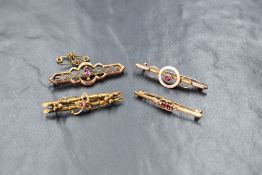 A group of four 9ct gold and yellow metal presumed gold garnet and spinel set bar brooches,