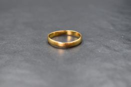 A 22ct gold band, of plain rounded form, marked 22, ring size R, 2.2g