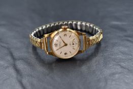 A vintage 18ct gold wrist watch by Heurlux, having baton & Arabic numeral dial with subsidiary