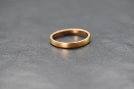 A 22ct gold band, of plain rounded form, marked 22 with hallmarks, ring size M, 2.7g