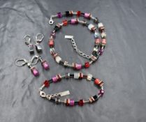 A suite of Coeur De Lion Geo Cube jewellery in tones of pink including necklace, bracelet &
