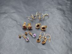 A group of five pairs of 9ct gold and yellow metal earrings, comprising two pairs of garnet set