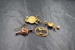 A yellow metal presumed gold South African gold mining motif brooch, the central 1/2 Pond coin