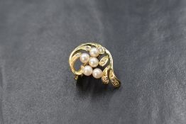 A 14ct gold seed pearl and diamond chip necklace clip/enhancer having a double row clip, decorated