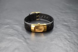 A boxed Christian Dior wristwatch, the golden square dial having Dior written as numerals, on a