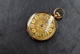 A small continental 18ct gold top wound open face pocket watch having a Roman numeral dial to