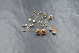 Five pairs of yellow metal earrings for pierced ears of different forms, some stamped 375 and