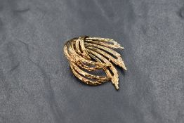 A yellow metal stylised brooch stamped 9ct of open swirl form, approx 4g