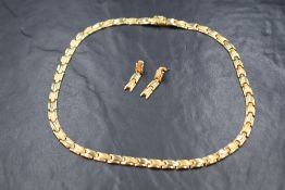 A yellow metal articulated necklace stamped 585 having brushed and polished links,concealed box