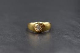 A yellow metal diamond gypsy ring having an old cut diamond, approx 0.25ct in a starburst setting,