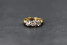 An 18ct gold diamond trilogy ring having three brilliant cut diamonds, approx 1ct total in a claw