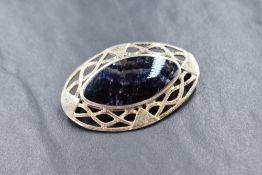 A silver Derbyshire Blue John brooch of oval form having a silver twist knot style mount, approx