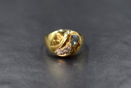 An 18ct gold aquamarine and diamond set ring, the pear cut aquamarine measuring approximately 0.38ct