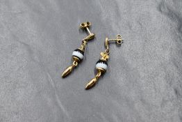 A pair of yellow metal earrings having drop chains with ring agate bead decoration, no marks but
