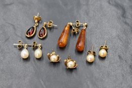 Five pairs of yellow metal earrings including Red cabochon paste drop, Baltic amber drop and three