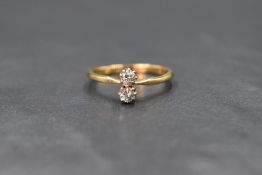 An 18ct gold diamond set toi et moi ring, the two round brilliant cut diamonds measuring