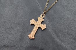 Two 9ct gold cross pendants, one having decorative engraving, one of plain form both marked 9ct,
