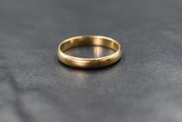 A 14ct gold band, of plain rounded form, marked 14K, ring size Q, 2.9g