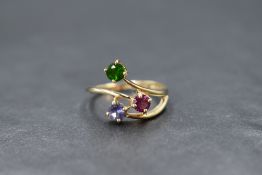 A 9ct gold three stone ring by QVC having a trio of gemstones in red, blue & green in an open