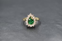 A 9ct gold green and white paste teardrop cluster ring in a claw set mount on a 9ct gold loop,