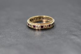 A 9ct gold ruby and white sapphire set full eternity band, the alternating princess cut rubies and