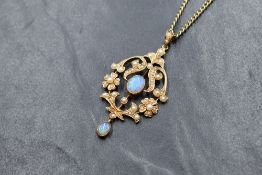 A 9ct gold opal and seed pearl set Edwardian style pendant, the central oval opal cabochon in a