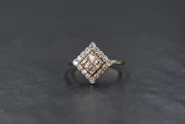 An 18ct white gold and platinum diamond cluster ring having four central princess cut diamonds