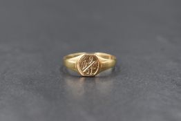 A 9ct gold signet ring, the rounded panel having 'CD' monogram and scroll engraving, marked 375,