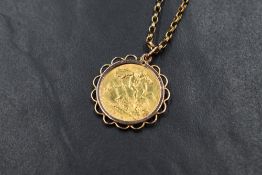 A 1914 half sovereign in a yellow metal removable pendant mount on a 9ct gold belcher link chain