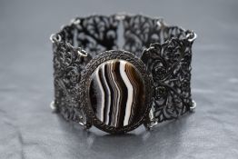 A Victorian Berlin Ironwork bracelet made up of six pierced floral decorative panels with an oval