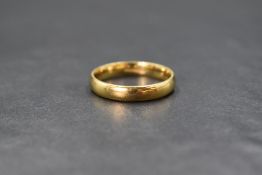 An 18ct gold band, of rounded plain form, marked 750, ring size V, 5.8g