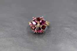 A 9ct gold garnet and amethyst open daisy cluster ring by QVC, having heart cut garnets interspersed