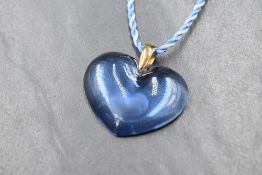 A boxed Lalique glass pendant, the transparent blue heart with a central concave frosted heart, on a
