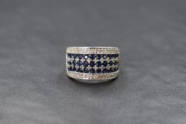 A QVC 9ct gold sapphire and diamond set band, the three rows of round cut sapphires interspersed