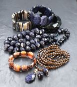 A stackers jewellery tray containing a small selection of modern costume jewellery including blue