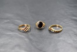 Three 9ct gold rings including a small signet ring with jet panel, split to loop, multi stone set