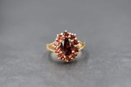 A 9ct gold fire opal cluster ring by QVC having a central oval fire opal within a surround of ten