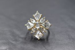 A 9ct gold aquamarine open flower ring by QVC, the aquamarines being marquise and kite cut in an