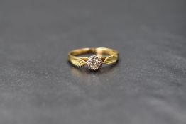 An 18ct gold diamond solitaire ring having a small diamond, approx 0.128ct in an illusionary set